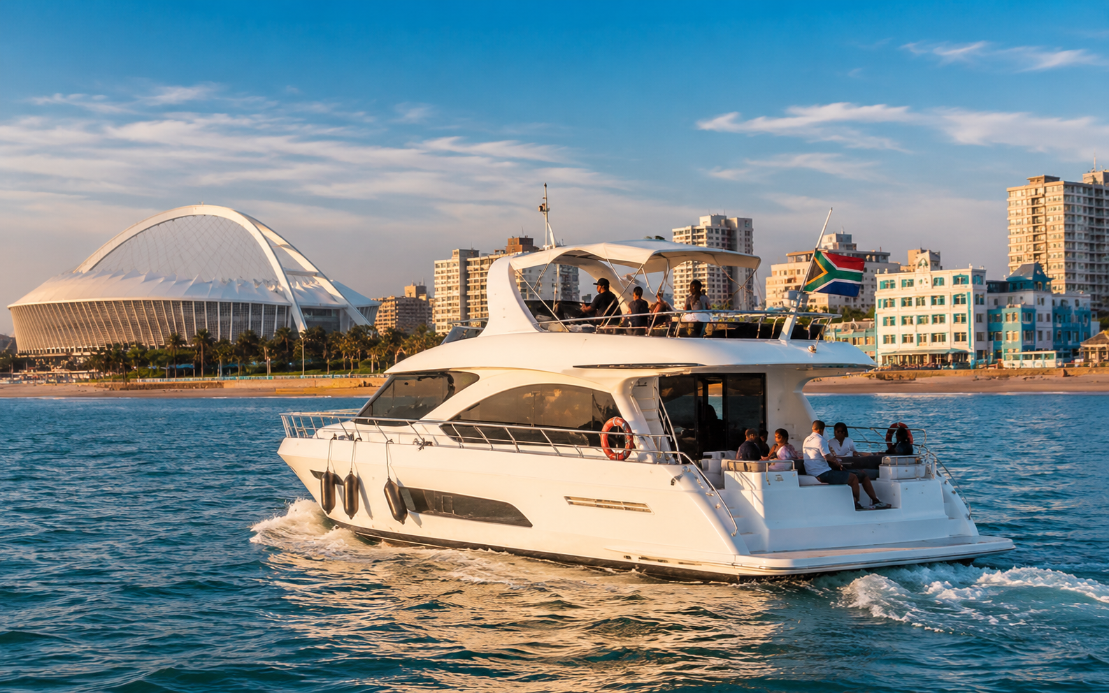 Yacht cruising past Durban's Golden Mile and Moses Mabhida Stadium