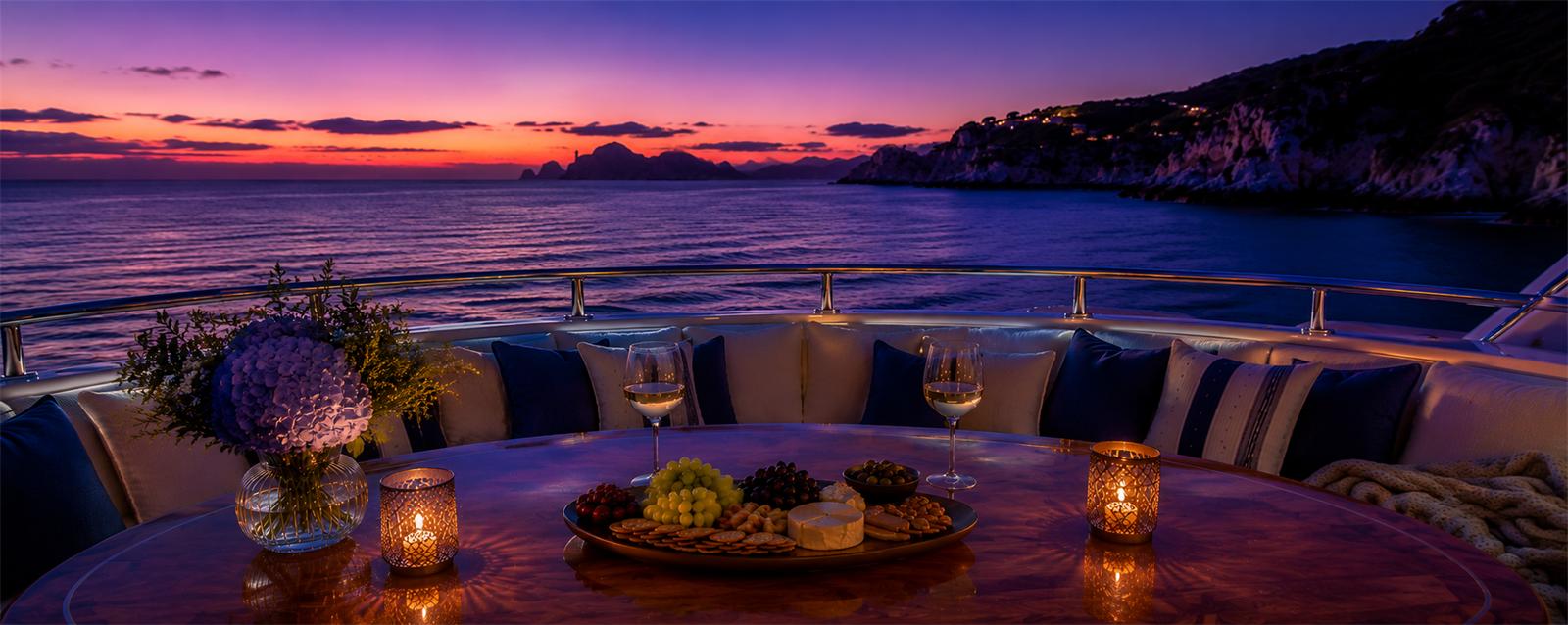 Romantic twilight dinner setting aboard the Versace Yacht
